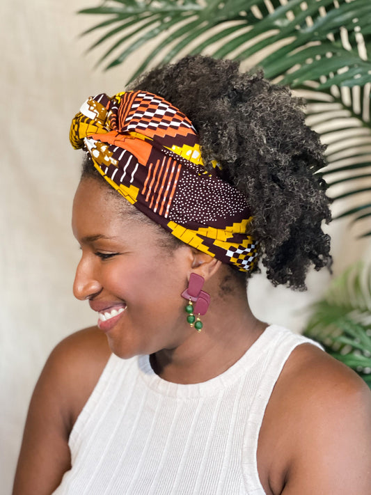 Woman wearing burgundy African-Inspired earrings with recycled glass beads Atiwo Designs