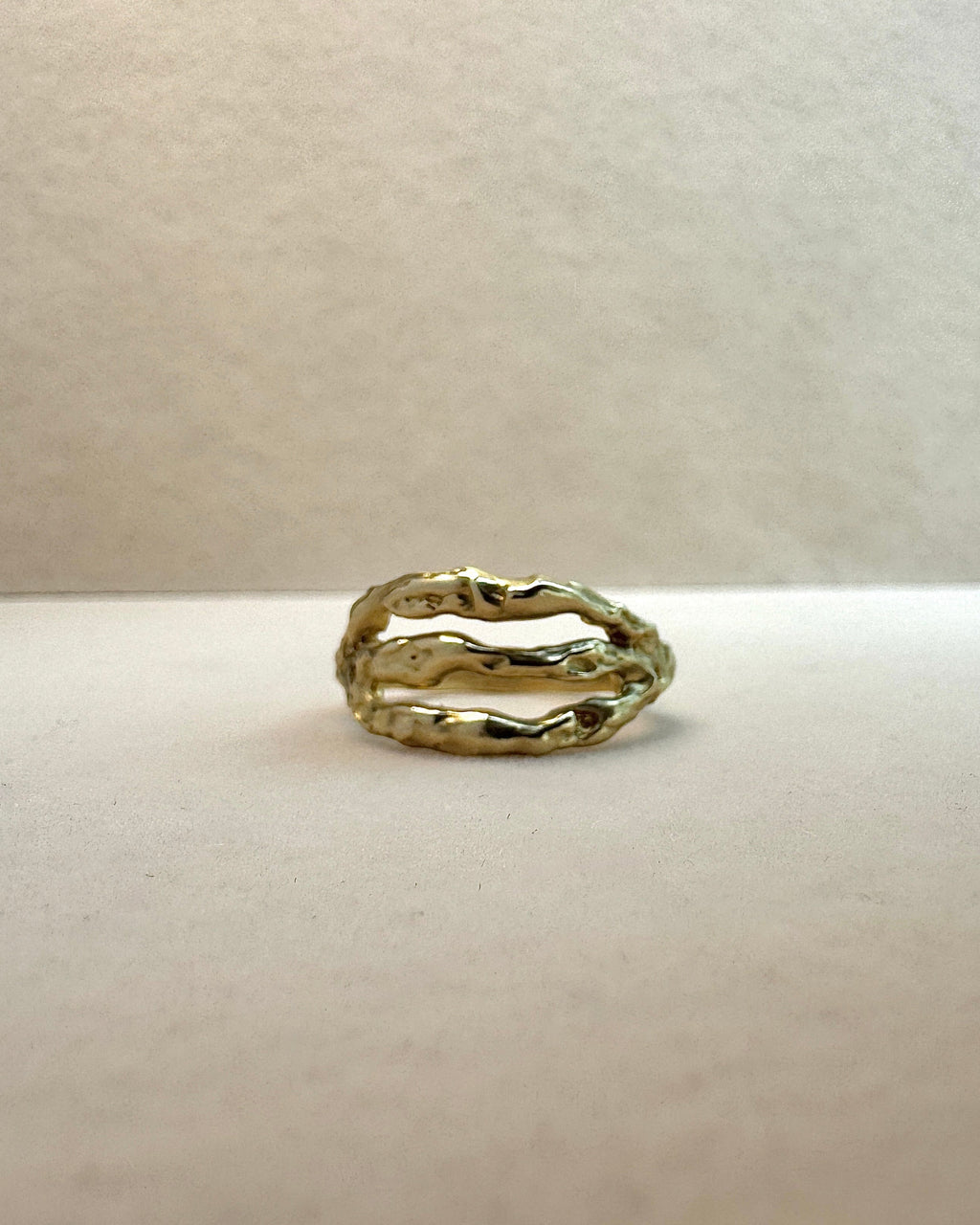 Gold ring on a light gray background