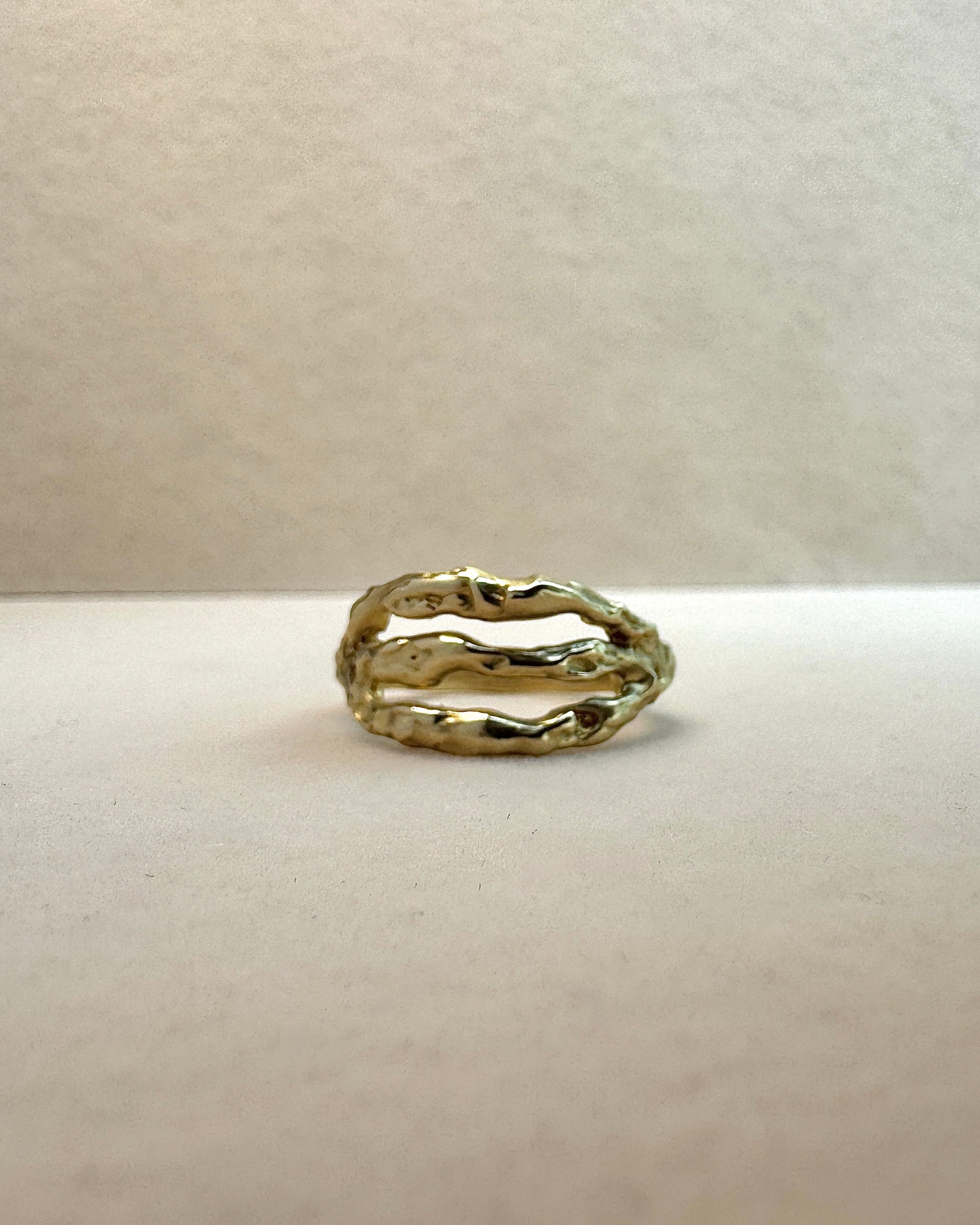 Gold ring on a light gray background