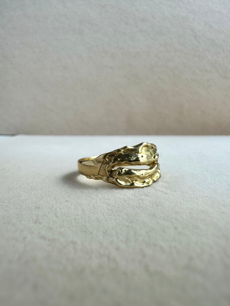Gold ring on a light gray background