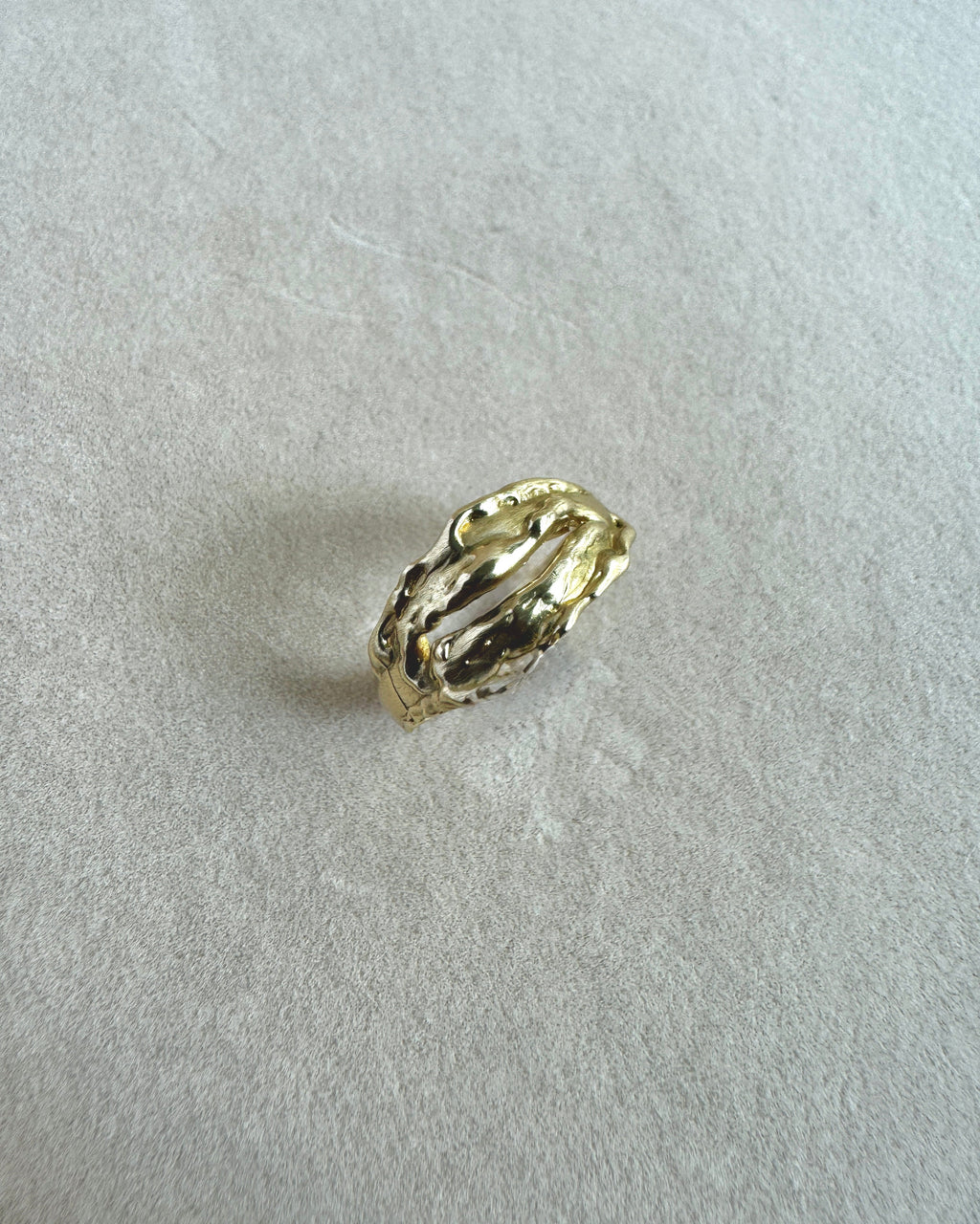 Gold ring on a light gray background