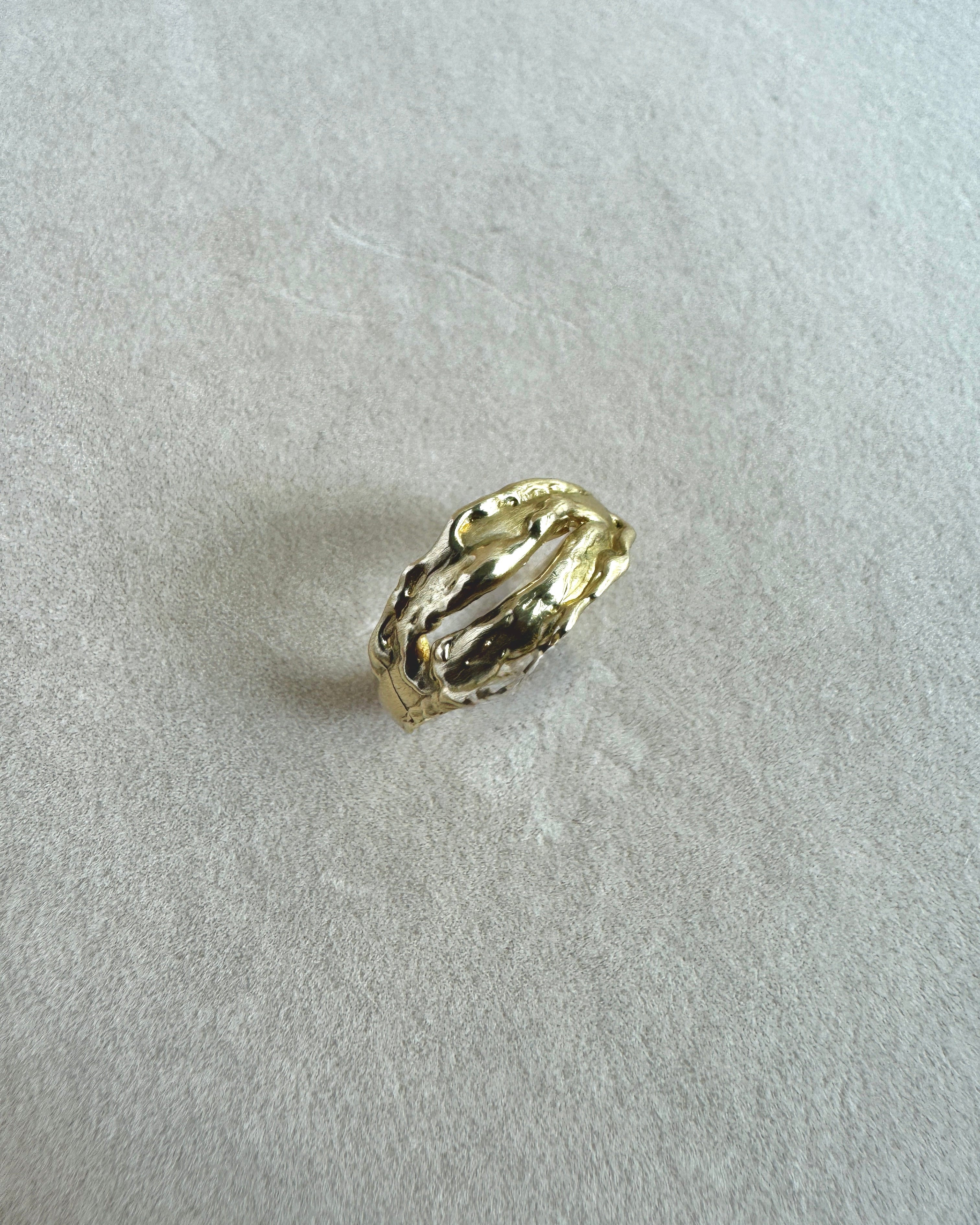 Gold ring on a light gray background