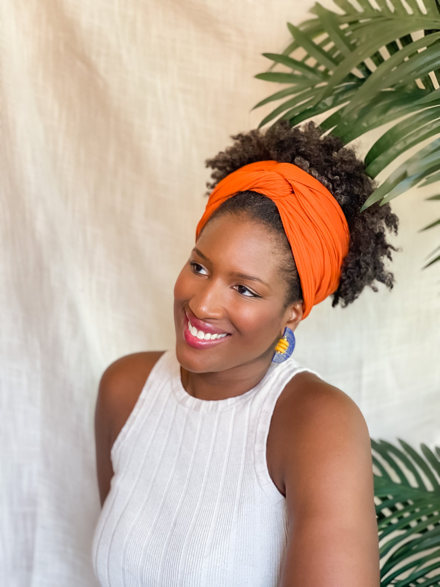 Woman wearing blue African-Inspired earrings with recycled glass beads Atiwo Designs