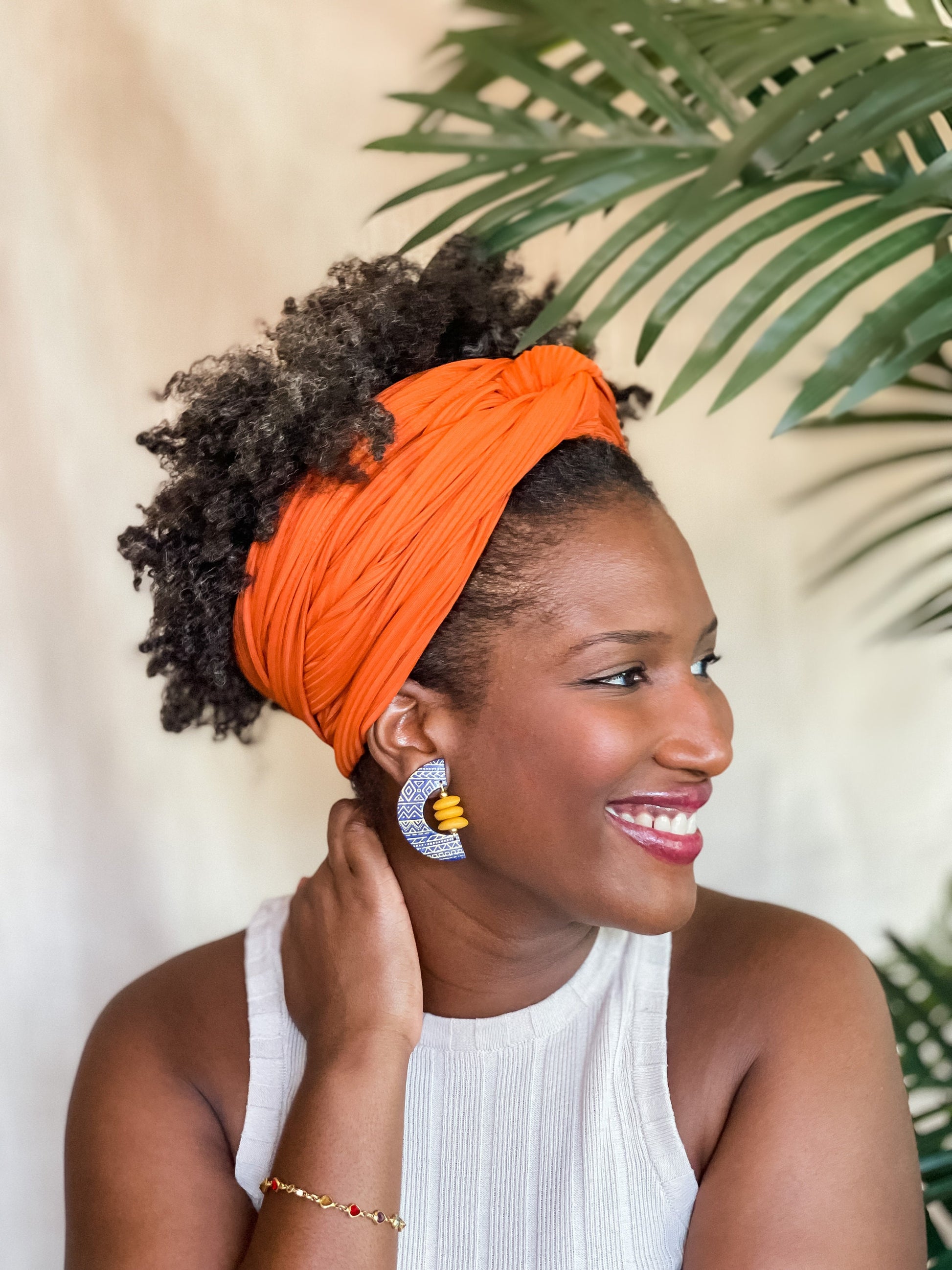 Woman wearing blue African-Inspired earrings with recycled glass beads Atiwo Designs