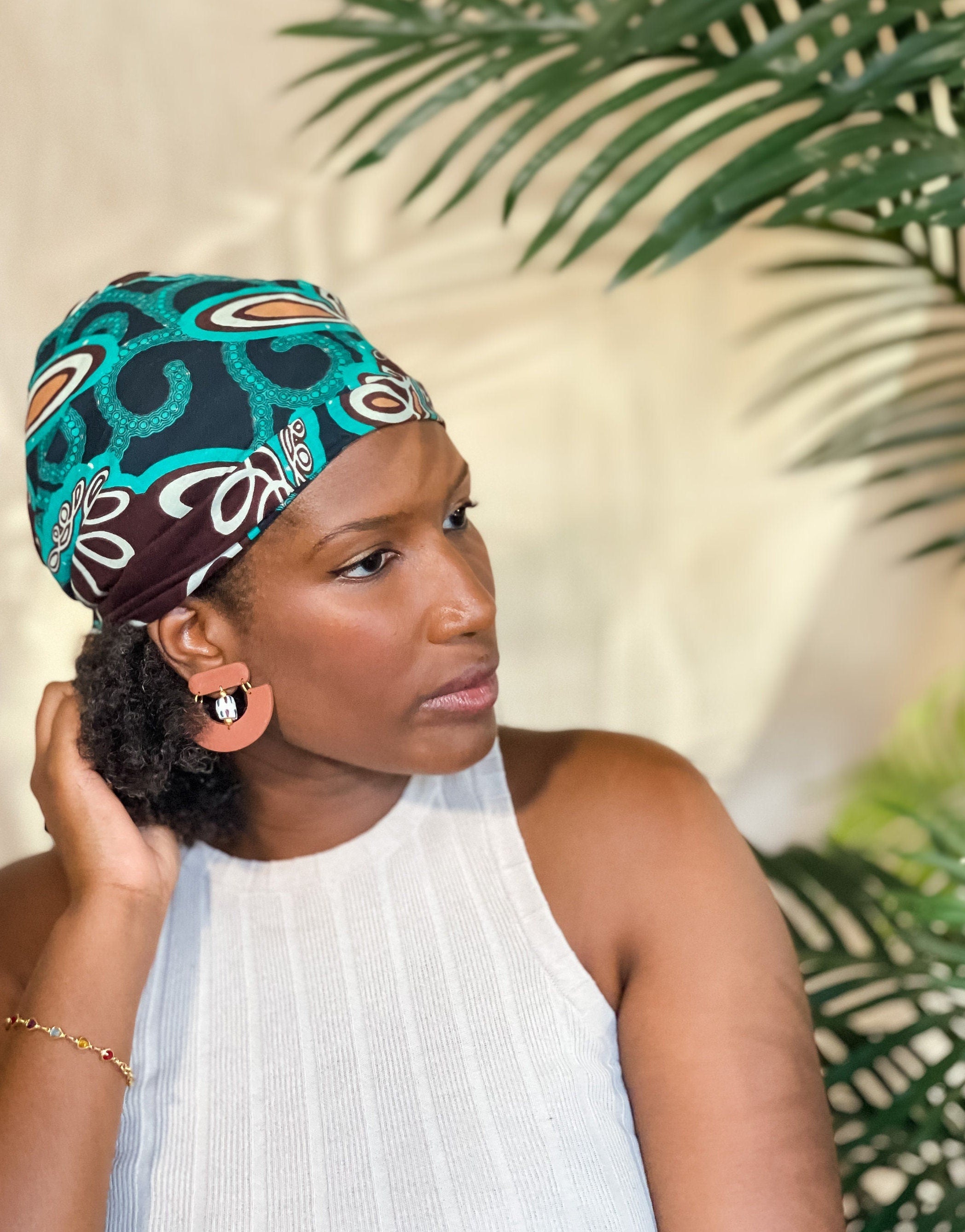 Woman wearing brown African-Inspired earrings with recycled glass beads Atiwo Designs
