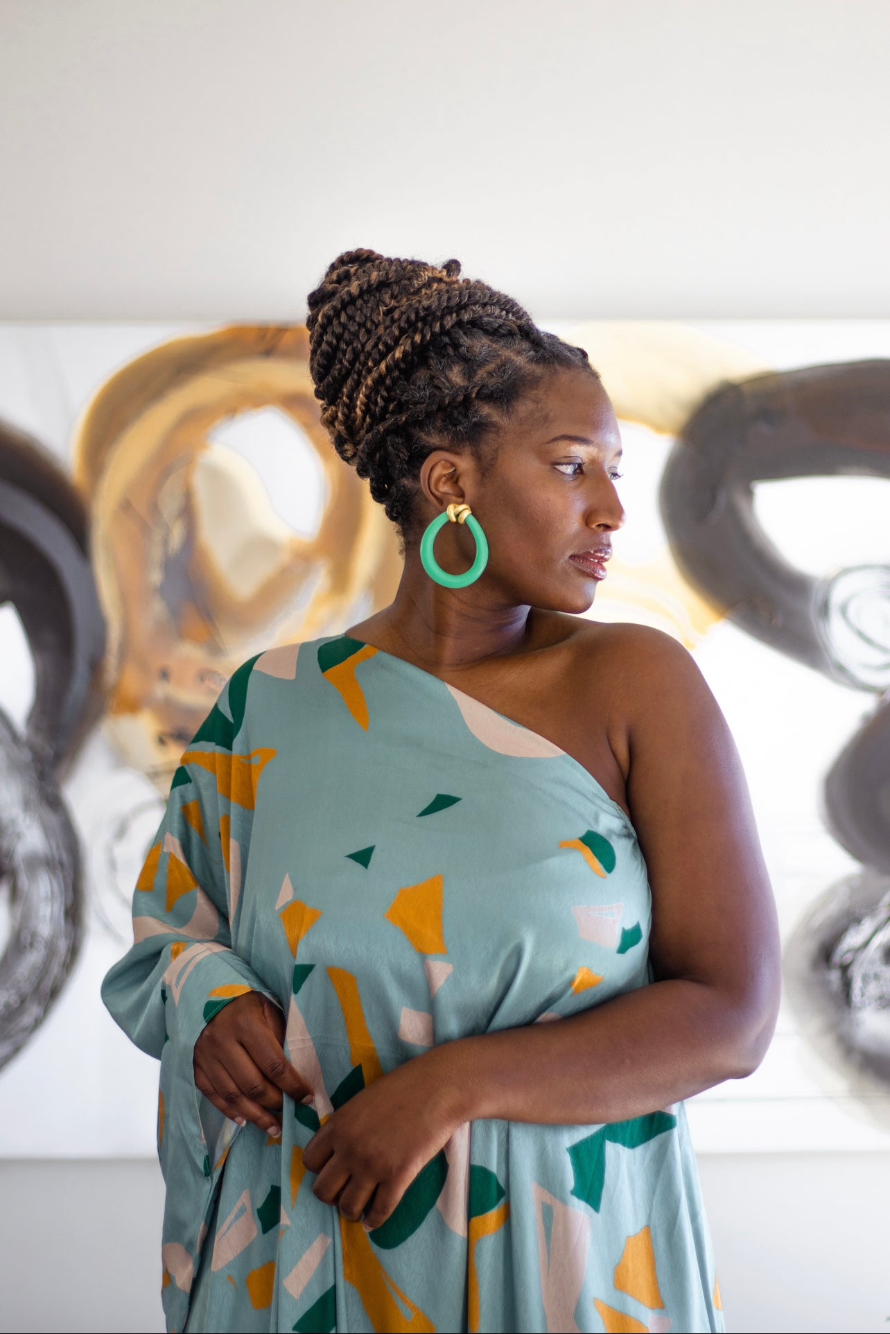 Woman wearing jade-inspired earrings with gold details Atiwo Designs