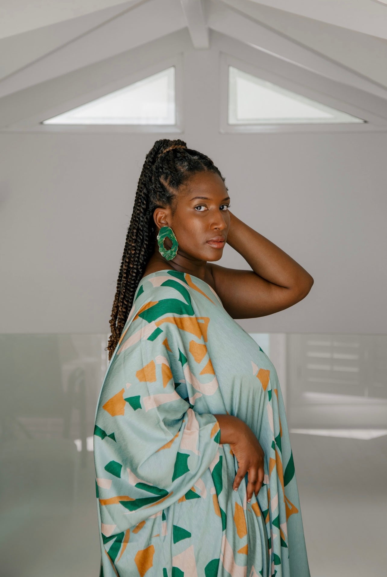 Woman wearing Jadeite earrings with gold trim Atiwo Designs